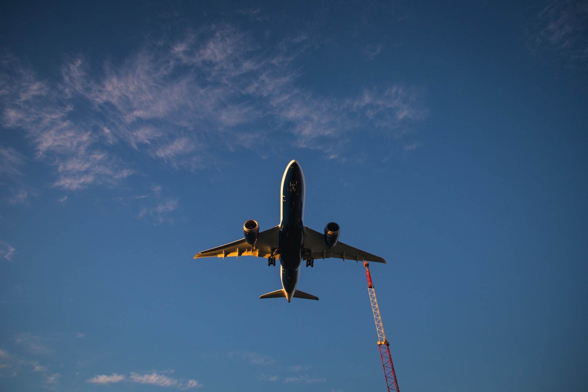 View from the ground of an airplane taking off in the sky.