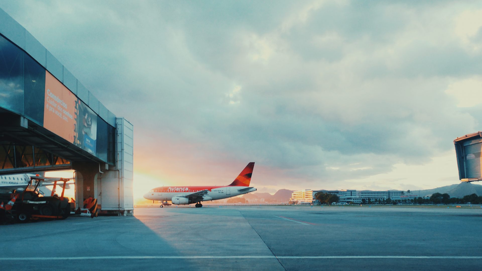 Orange plan waiting at gate during sunrise.